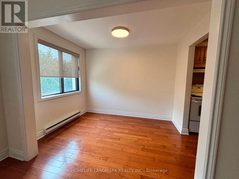 A room with wooden floors and a window.