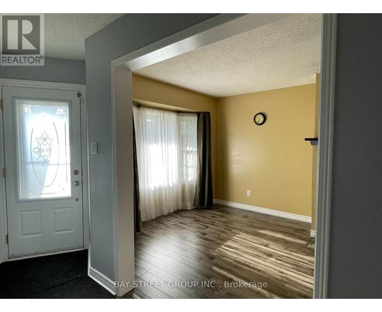 A room with a white door and a clock on the wall.
