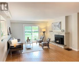 A living room with a fireplace and a television.