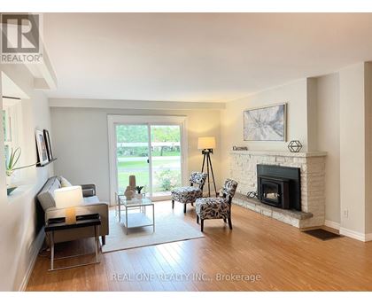 A living room with a fireplace and a television.