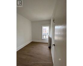 A room with a window and a radiator on the wall.