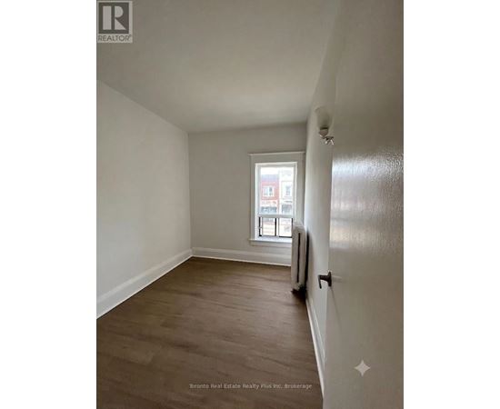 A room with a window and a radiator on the wall.