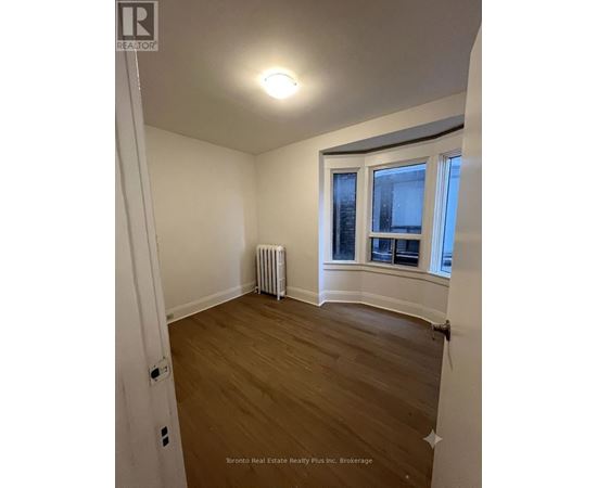 A room with a window and a radiator.