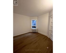 A room with wooden floors and white walls.