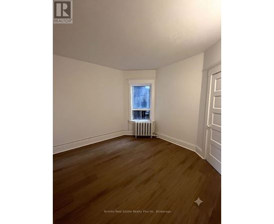 A room with wooden floors and white walls.