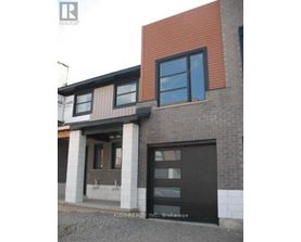 A modern house with a black door and windows.