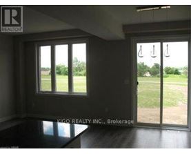 A room with a sliding glass door leading to a grassy area.