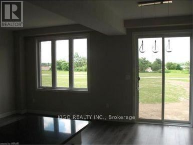 A room with a sliding glass door leading to a grassy area.