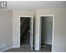 A room with a staircase and a glass door.
