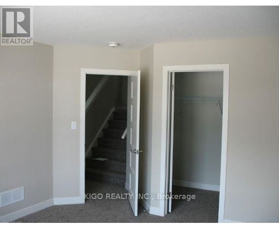 A room with a staircase and a glass door.