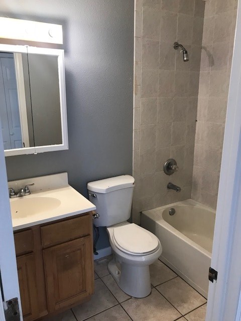 A white toilet sits next to a sink in a bathroom.
