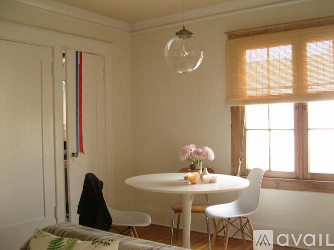 A small dining room with a table and chairs.