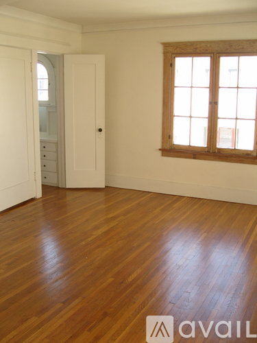 A room with wooden floors and a window.