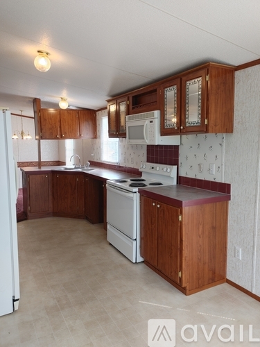 A kitchen with wooden cabinets and a white oven.