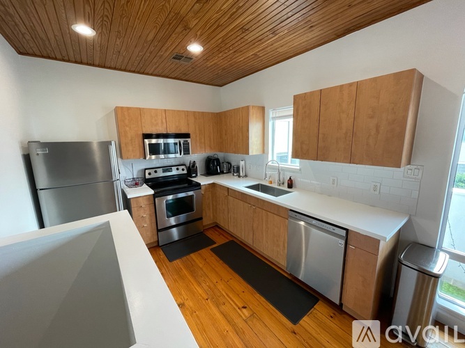 A kitchen with wooden cabinets and stainless steel appliances.