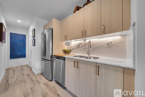 A kitchen with wooden cabinets and a marble countertop.