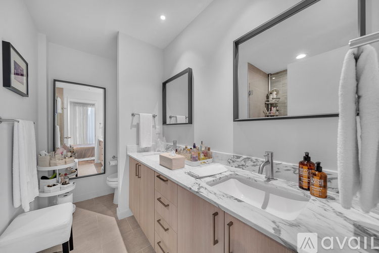 A bathroom with a white towel hanging on the towel rack.