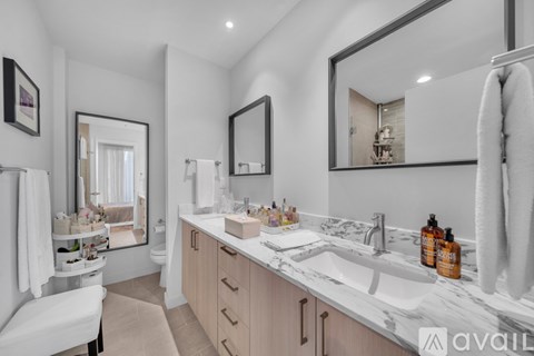 A bathroom with a white towel hanging on the towel rack.
