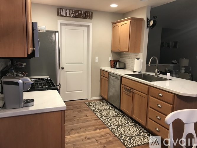 A kitchen with wooden cabinets and a white door.