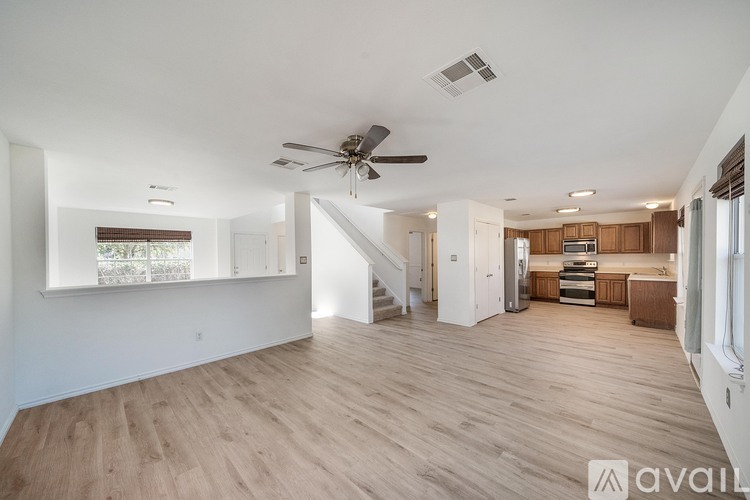 A spacious living room with a staircase leading to the upper floor.