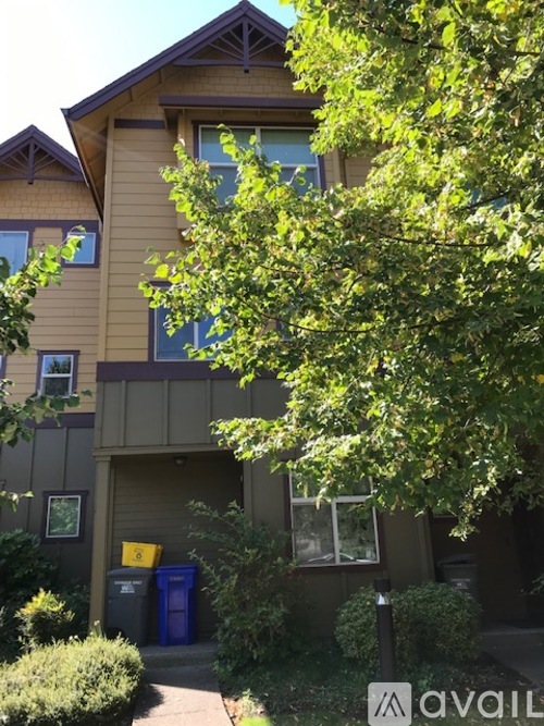 A brown building with a tree in front of it.