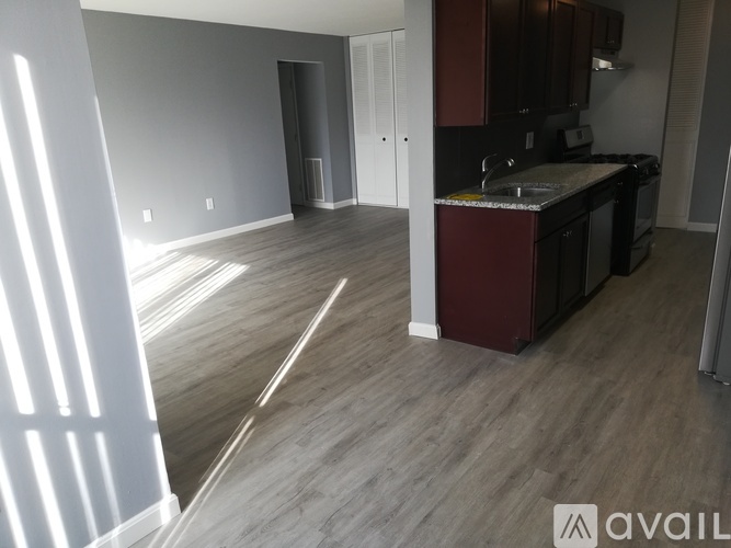 A kitchen area with a sink and cabinets.