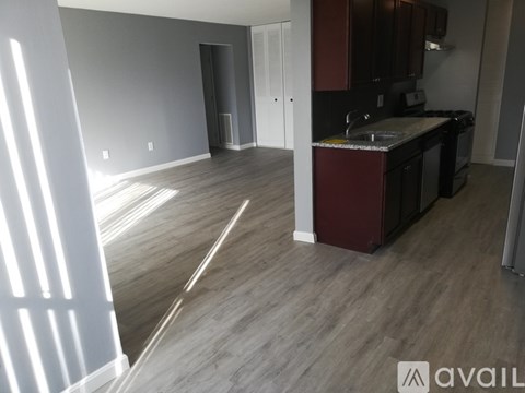 A kitchen area with a sink and cabinets.
