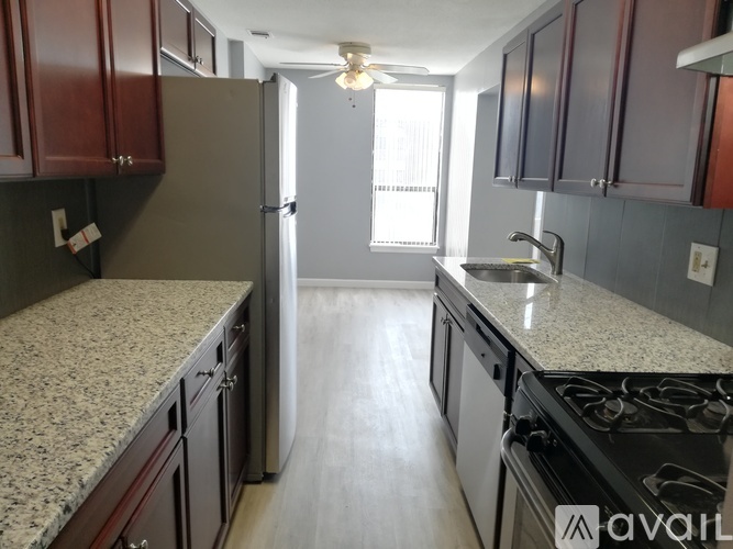 A kitchen with granite countertops and a stove top oven.