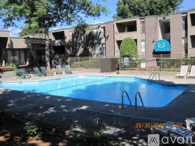 A pool in front of apartment buildings.