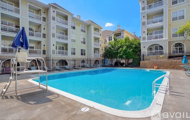 A swimming pool in front of apartment buildings.