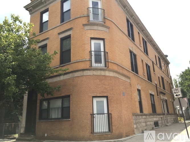 A red brick building with a balcony on the second floor.