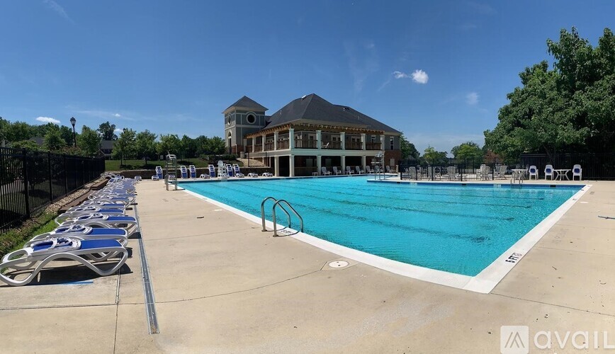 A large outdoor swimming pool with a building in the background.