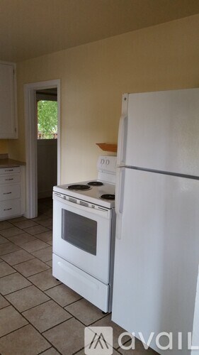 A white fridge and oven in a kitchen.