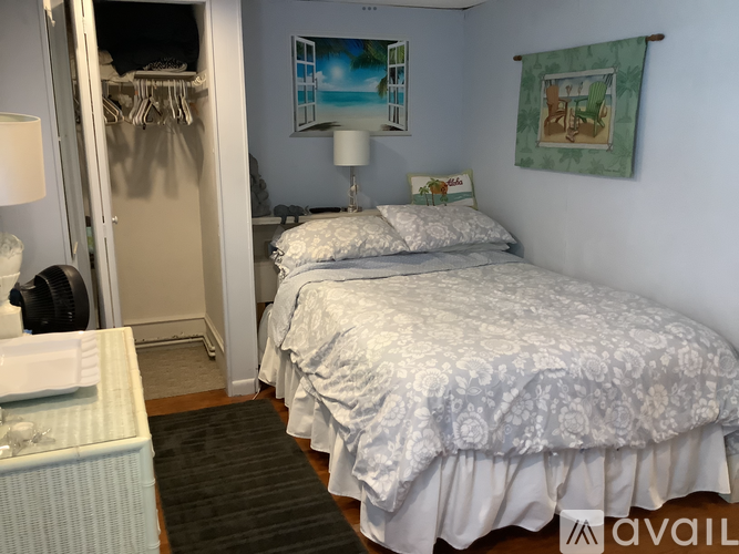 A bedroom with two beds and a wardrobe.