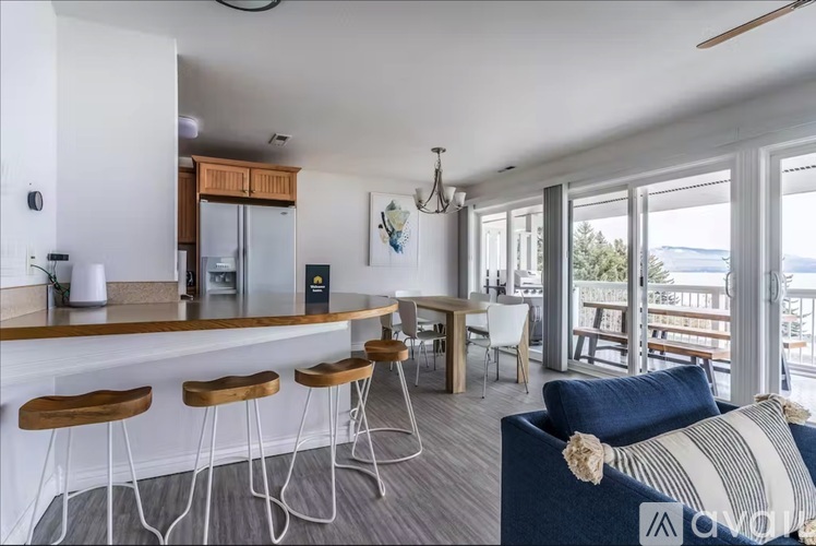 A kitchen with a bar area and a dining table with chairs.