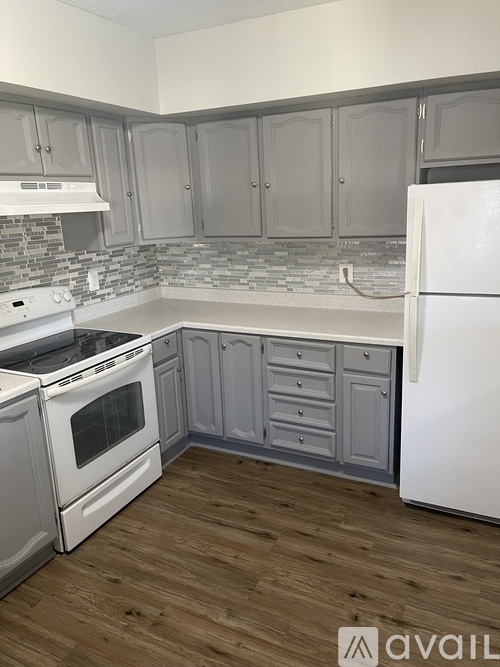 A kitchen with a white fridge and a white stove.