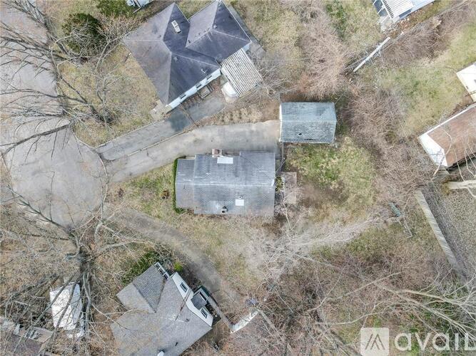 A bird's eye view of a property with a large grey building in the center.