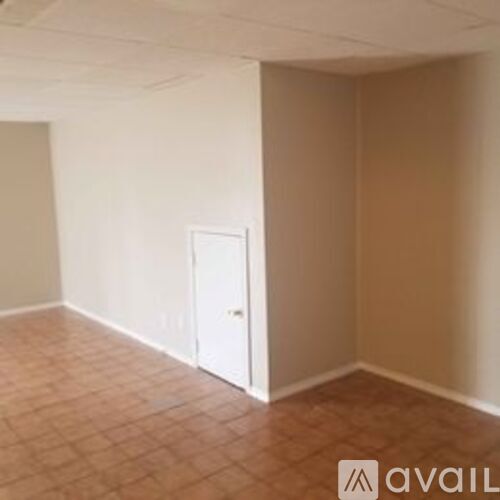 A room with a door and tiled flooring.