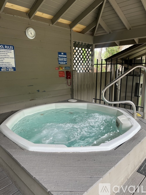 A hot tub with a sign on the wall above it.
