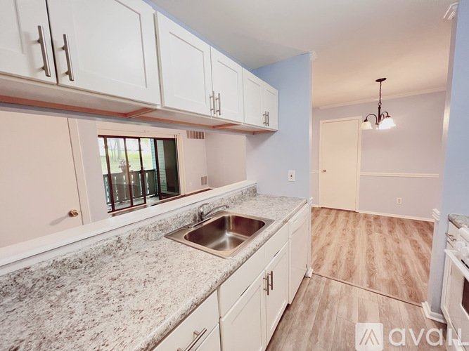 A kitchen with a sink and cabinets.