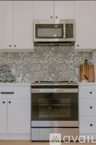A kitchen with a stove top oven and a microwave above it.