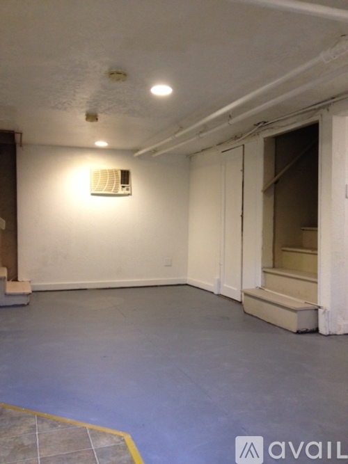 A room with a white wall and a window.