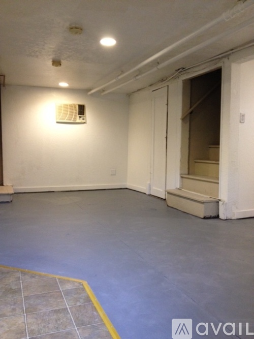 A room with a white wall and a yellow line on the floor.