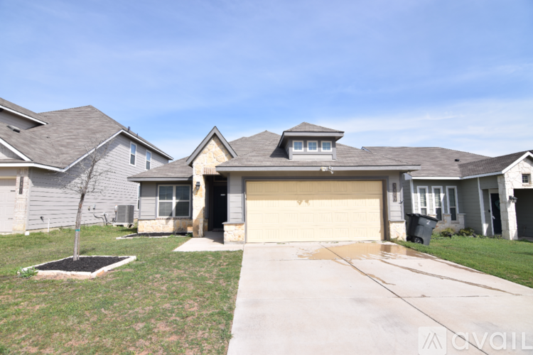 A house with a grey roof and a brown garage door.
