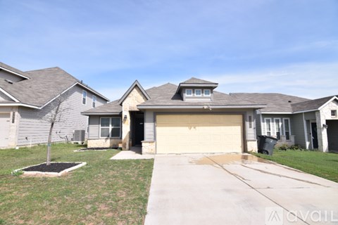A house with a grey roof and a brown garage door.