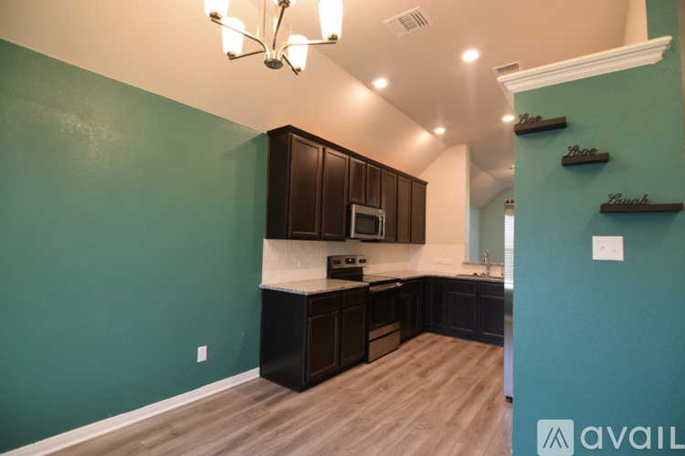 A kitchen with dark wood cabinets and a white countertop.