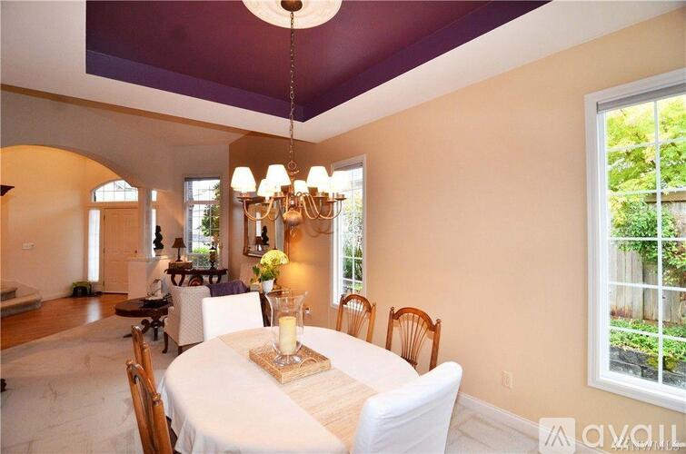 A dining room with a table set for a meal.