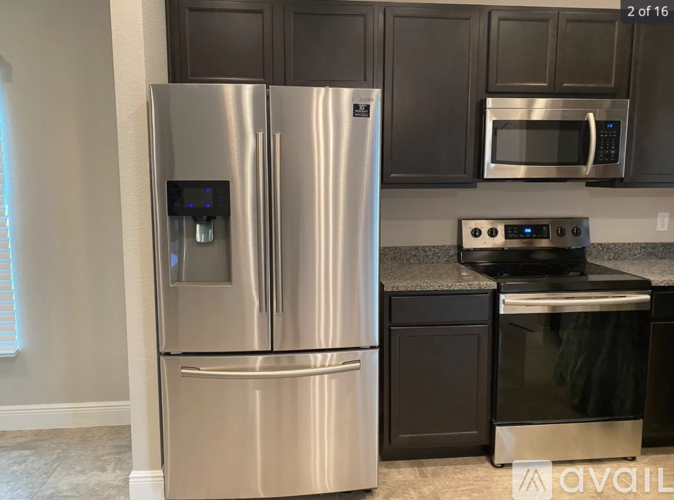 A stainless steel refrigerator with a water and ice maker dispenser.