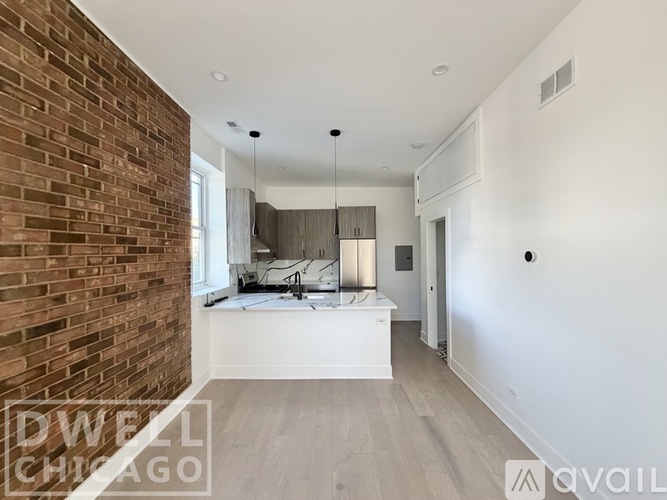 A room with a brick wall and a white countertop.