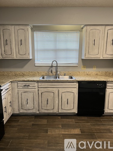 A kitchen with a sink and cabinets.